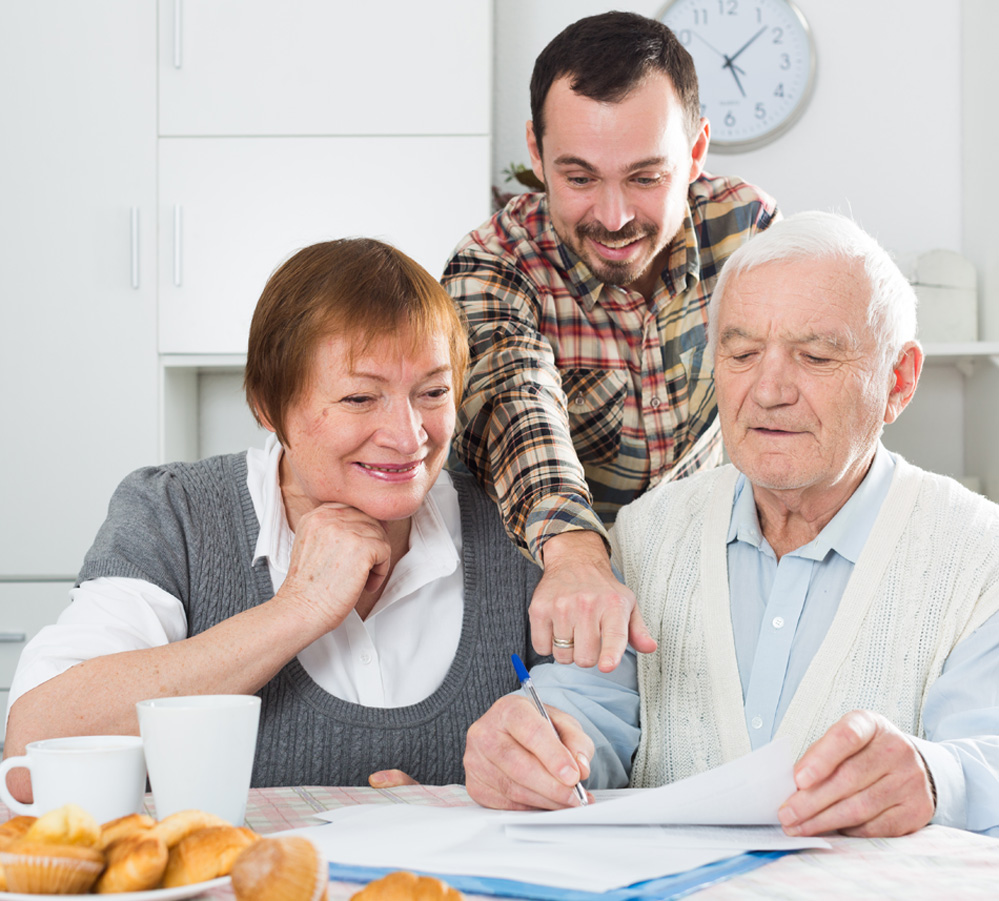 3 people looking excitedly at a piece of paper