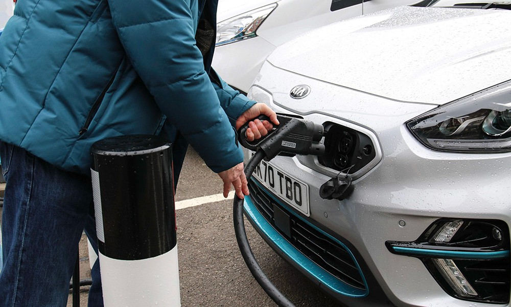Someone charging an electric car