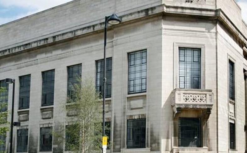Image of the Central library in Tudor Square. A cream building with lots of windows