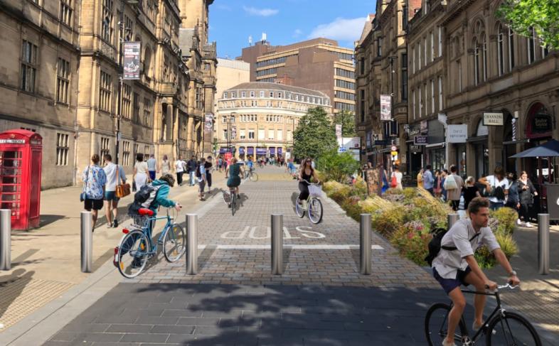 An artist impression of the pedestrianised Surrey Street with the Town Hall on the left, businesses on the right and people either walking or cycling along the middle of the picture