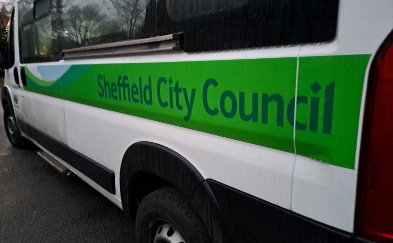 A Sheffield City Council mini bus with green branding down the side