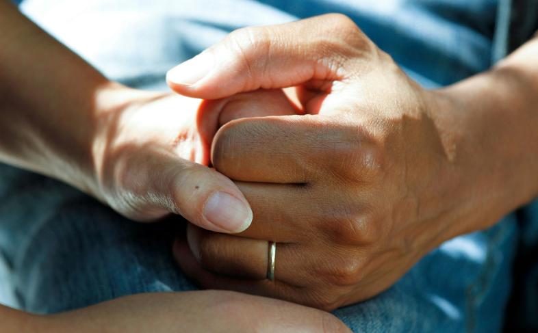 Two people holding hands 
