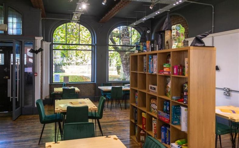 Inside the Gamers Guide Cafe - tables, chairs and board games on display inside the cafe 