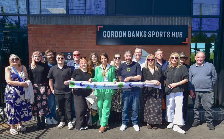 Individuals gathered at the opening of the Gordon Banks Sports hub 
