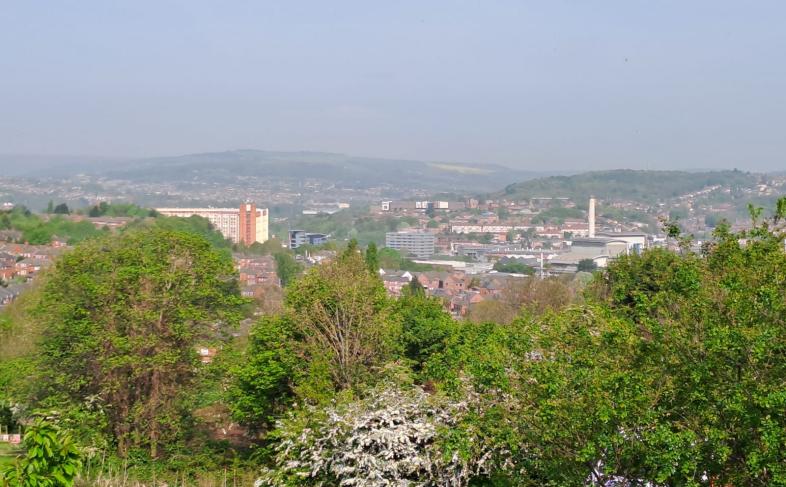 A view over Sheffield from The Manor looking towards Park Hill and the city centre on a sunny day