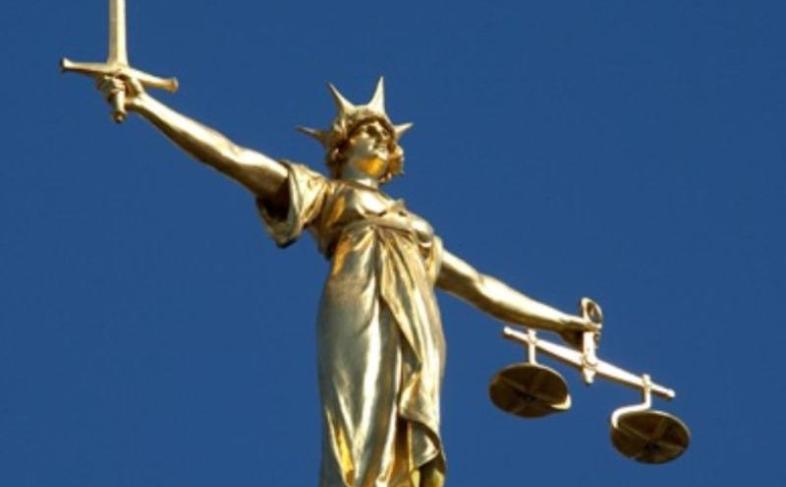 Gold on blue background 'Scales of justice'