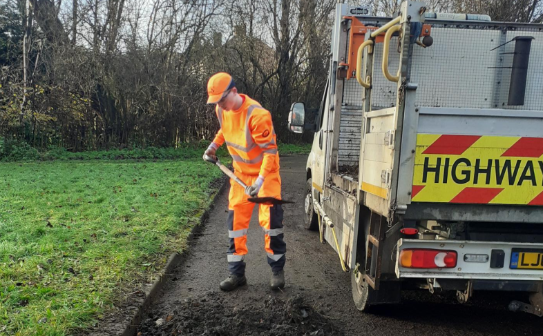 Man in high vis laying tarmac 
