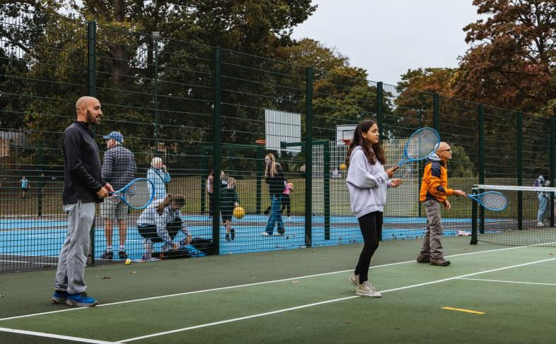 People enjoying tennis at the courts 