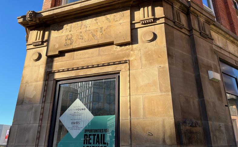 An image of the outside of a building with the brickwork showing the old 'Midland Bank' sign on it