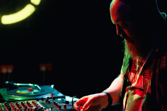 A DJ is playing music on stage.
