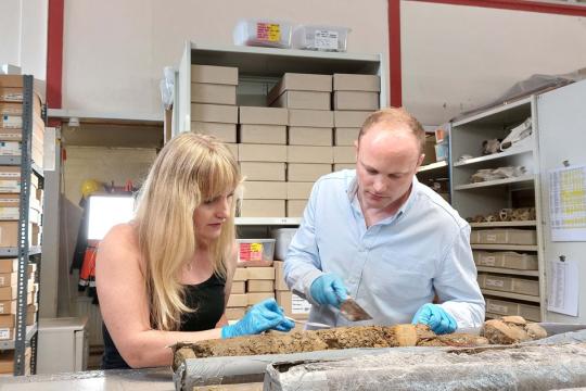 Archaeologist and Digging for Britain presenter Dr Cat Jarman with Dr Daniel Young from Wessex Archaeology examining the Sheffield Castle core samples at the Wessex Archaeology labs