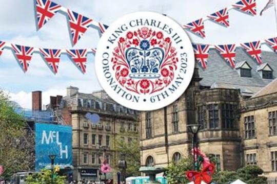 Picture of Sheffield Town Hall in the background with the Peace Gardens in the foreground with computer generated bunting at the top of the picture and the King's Coronation logo in the middle of the bunting