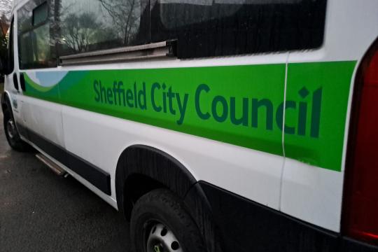 A Sheffield City Council mini bus with green branding down the side