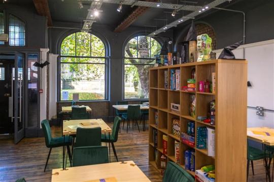 Inside the Gamers Guide Cafe - tables, chairs and board games on display inside the cafe 