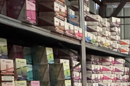 Illegal vapes stacked on metal shelving