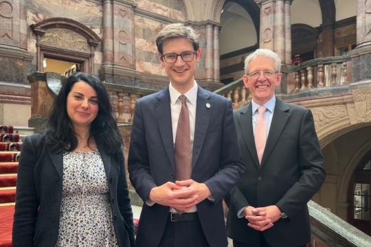 The three party leaders smile on the brightly lit main staircase at Sheffield Town Hall. From left, Cllr Angela Argenzio from the Green Group, Cllr Tom Hunt of the Labour Group, also the Leader of the Council, and Cllr Martin Smith of the Liberal Democrat Group