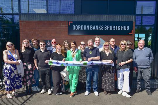 Individuals gathered at the opening of the Gordon Banks Sports hub 