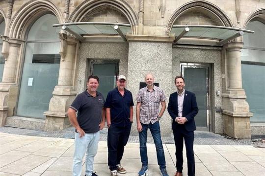 Cllr Ben Miskell and representatives of Thornbridge & Co outside what will be The Fargate pub on Fargate, but what is currently an empty building
