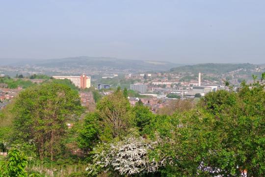 A view over Sheffield from The Manor looking towards Park Hill and the city centre on a sunny day