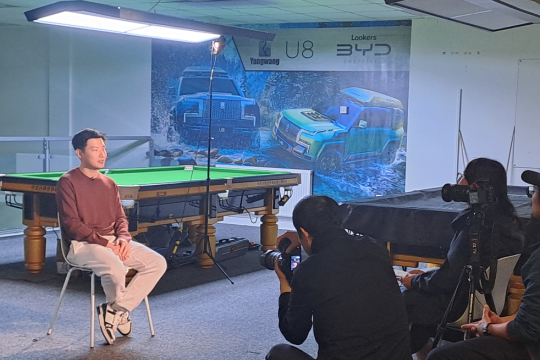 Zhao Xington being interviewed by reporters in front of snooker table