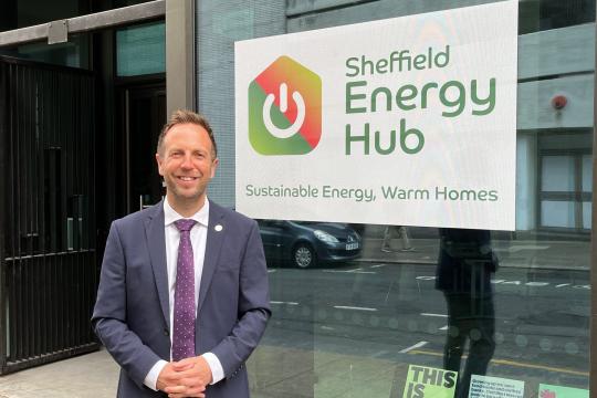 Cllr Ben Miskell stands outside the Sheffield Energy Hub building with the main sign in the background on the window