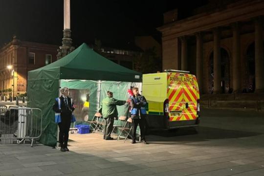 An ambulance and green tent in Barkers Pool at night