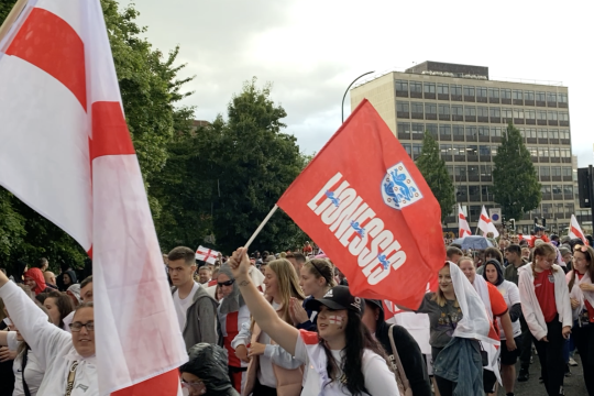  A crowd of football fans on the streets of the city centre with England flags.