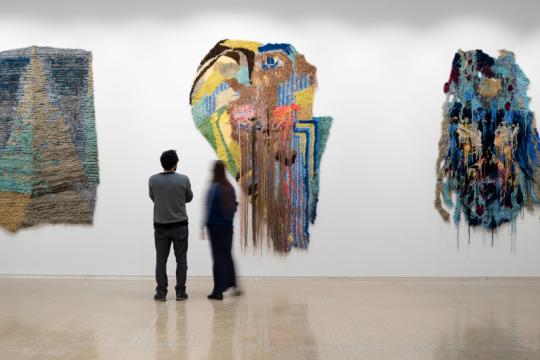People looking at colourful artwork