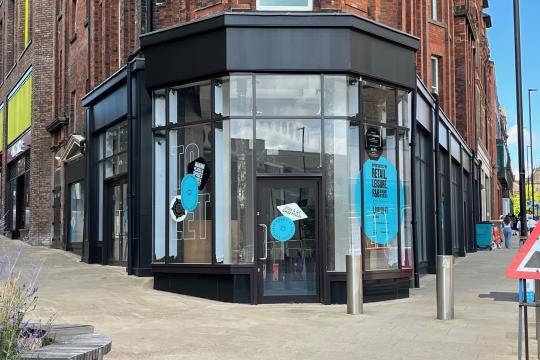 Picture shows the front of the a shop unit located on the corner of two streets