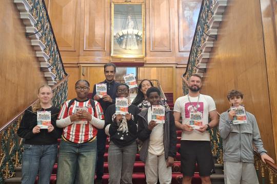 Young people holding their sector safari booklets