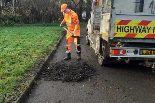 Man in high vis laying tarmac 