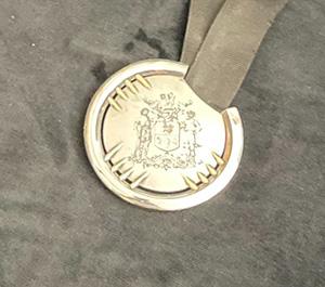 Lord Mayor’s Consort’s Badge, the central form is made of sterling silver, it has 12 gold arrows that intersect with the Sheffield Coat of Arms.